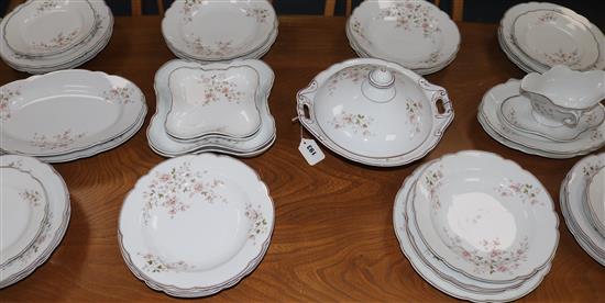 A Continental part dinner service, gilt-lined and decorated floral and foliate sprays in pale pink and green,